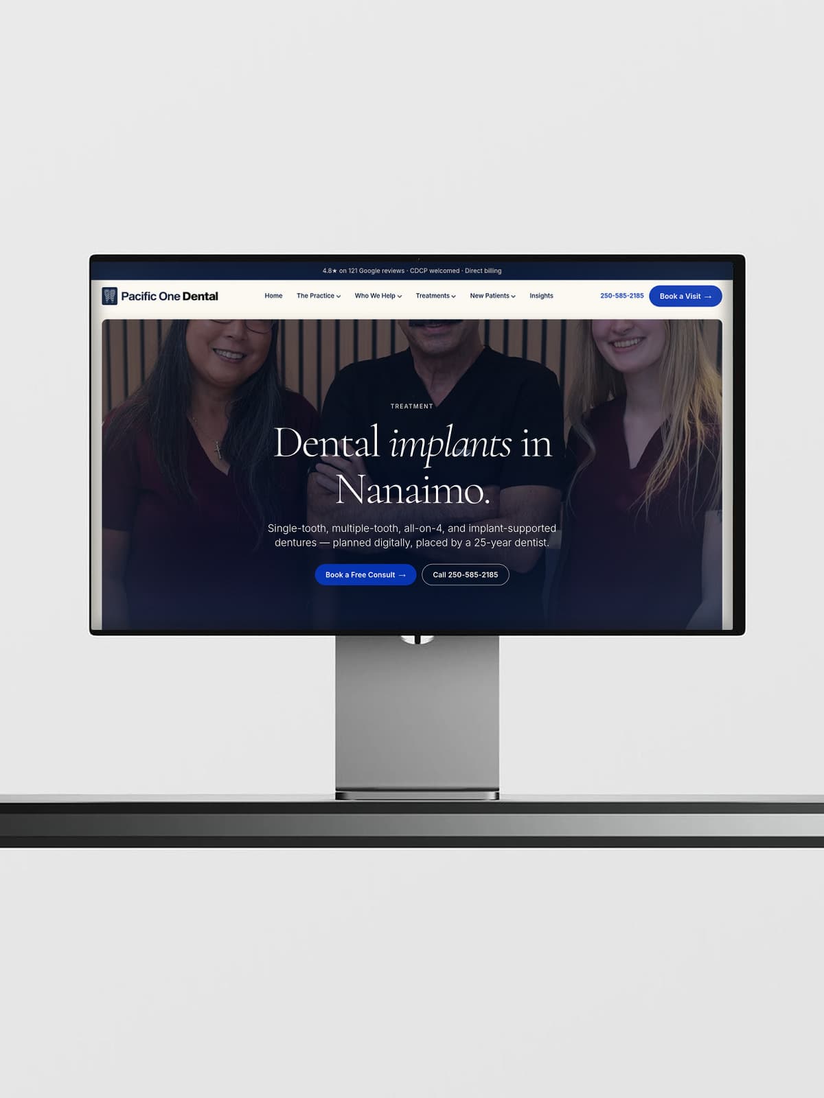 Pacific One Dental implants page on a desktop display, with the treatment hero and a Nanaimo booking call to action
