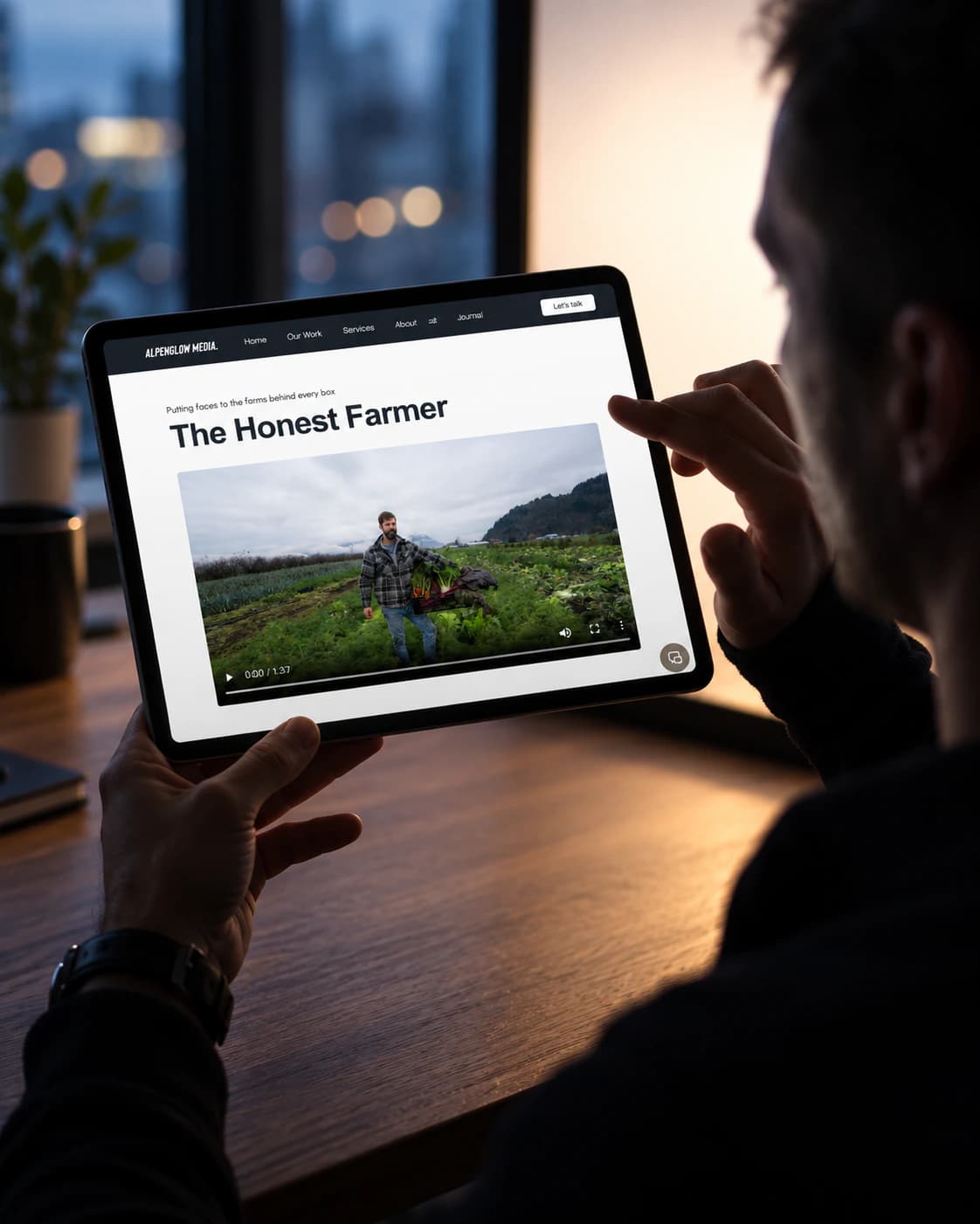 Alpenglow Media The Honest Farmer project page on a tablet, held at a desk