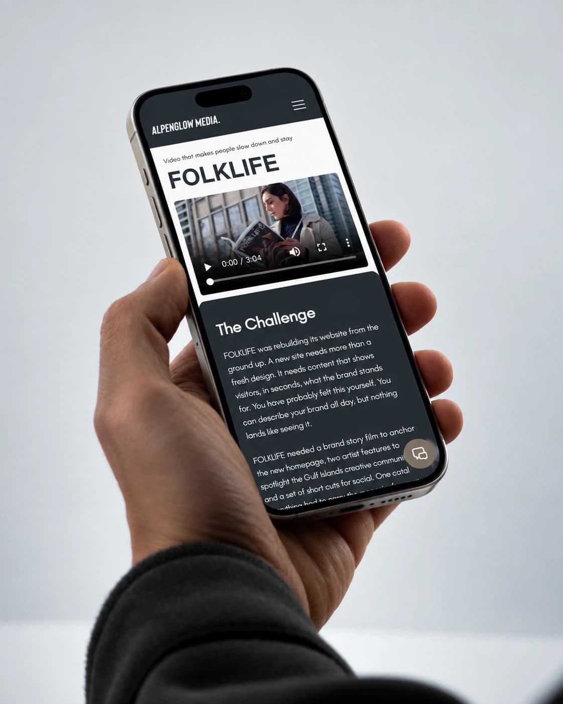 Alpenglow Media FOLKLIFE project page on a phone, held in hand