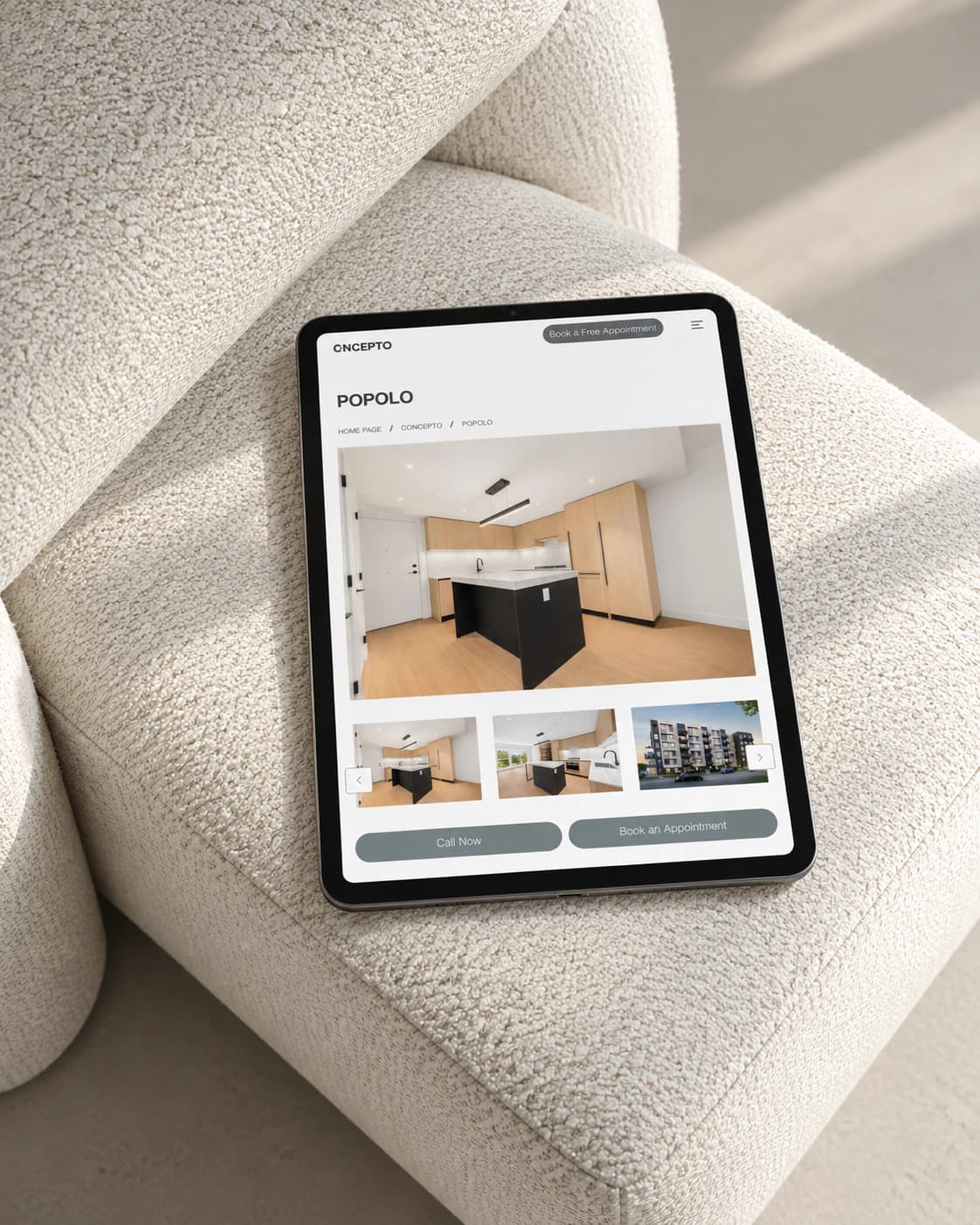 Concepto Interiors POPOLO project page on a tablet, on a boucle armchair