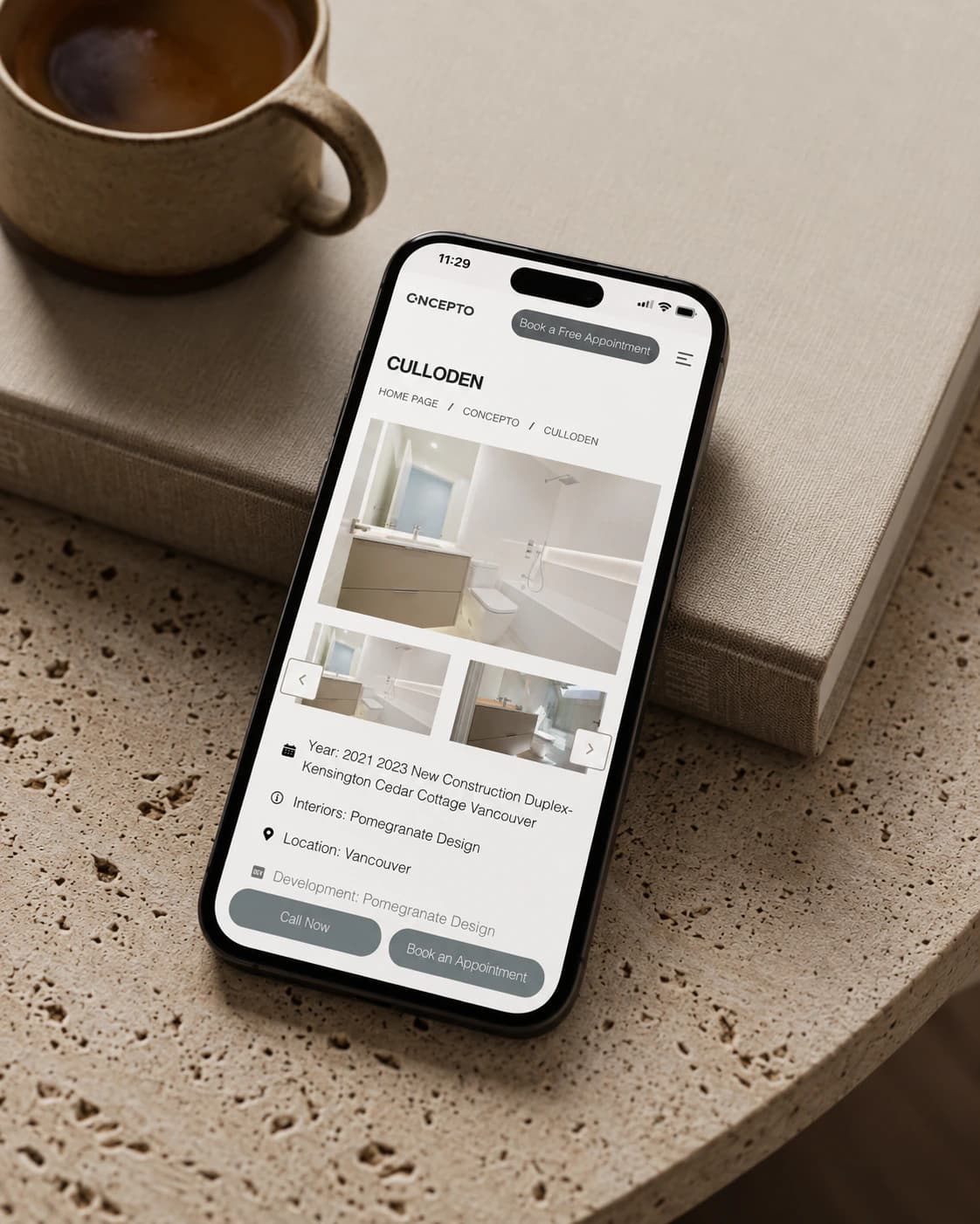 Concepto Interiors CULLODEN project page on a phone, on a stone table beside a coffee cup