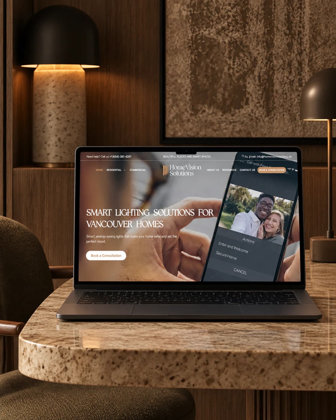 Home Vision Solutions homepage on a laptop, on a marble side table: smart lighting for Vancouver homes