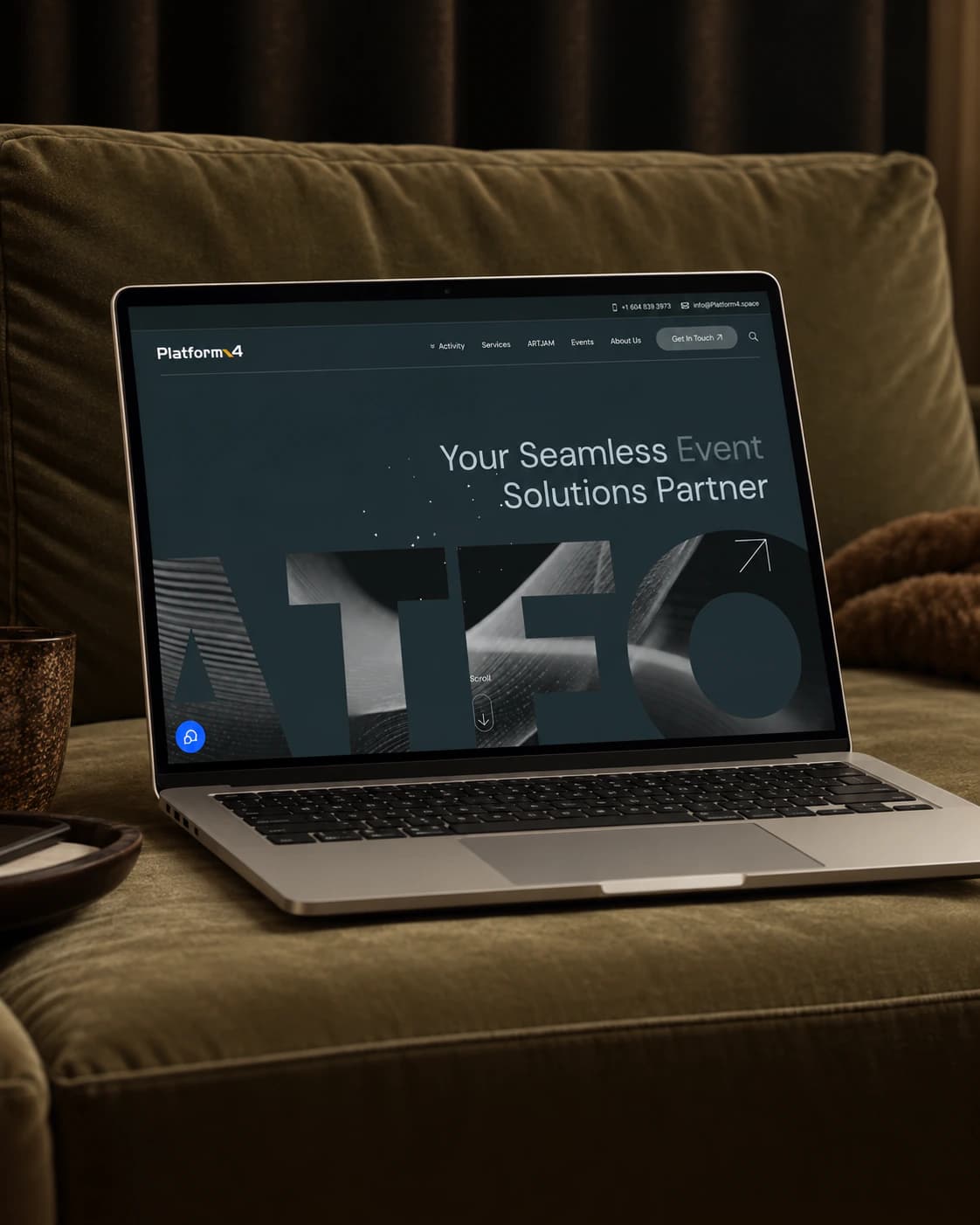 Platform4 event space homepage on a laptop, on a green velvet sofa
