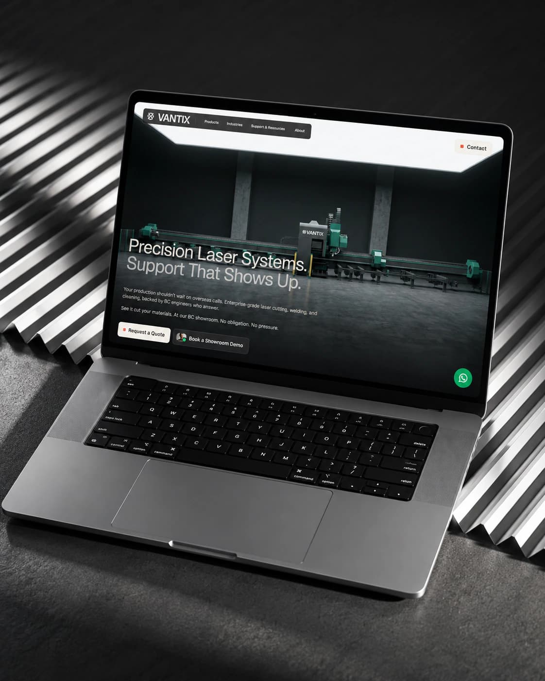 Vantix Industrial Lasers homepage on a laptop, on corrugated steel: Precision Laser Systems hero